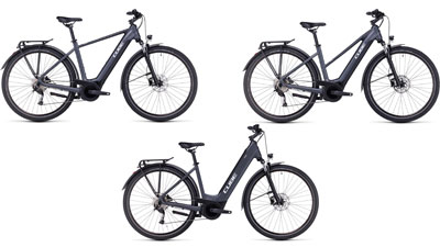 On display are three gray Cube Touring Hybrid ONE e-bikes, each with a diamond frame, a trapezoidal frame, and a low step-through frame.