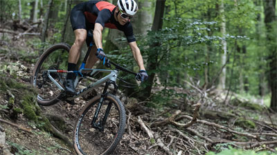 You can see a cyclist riding down a hill.